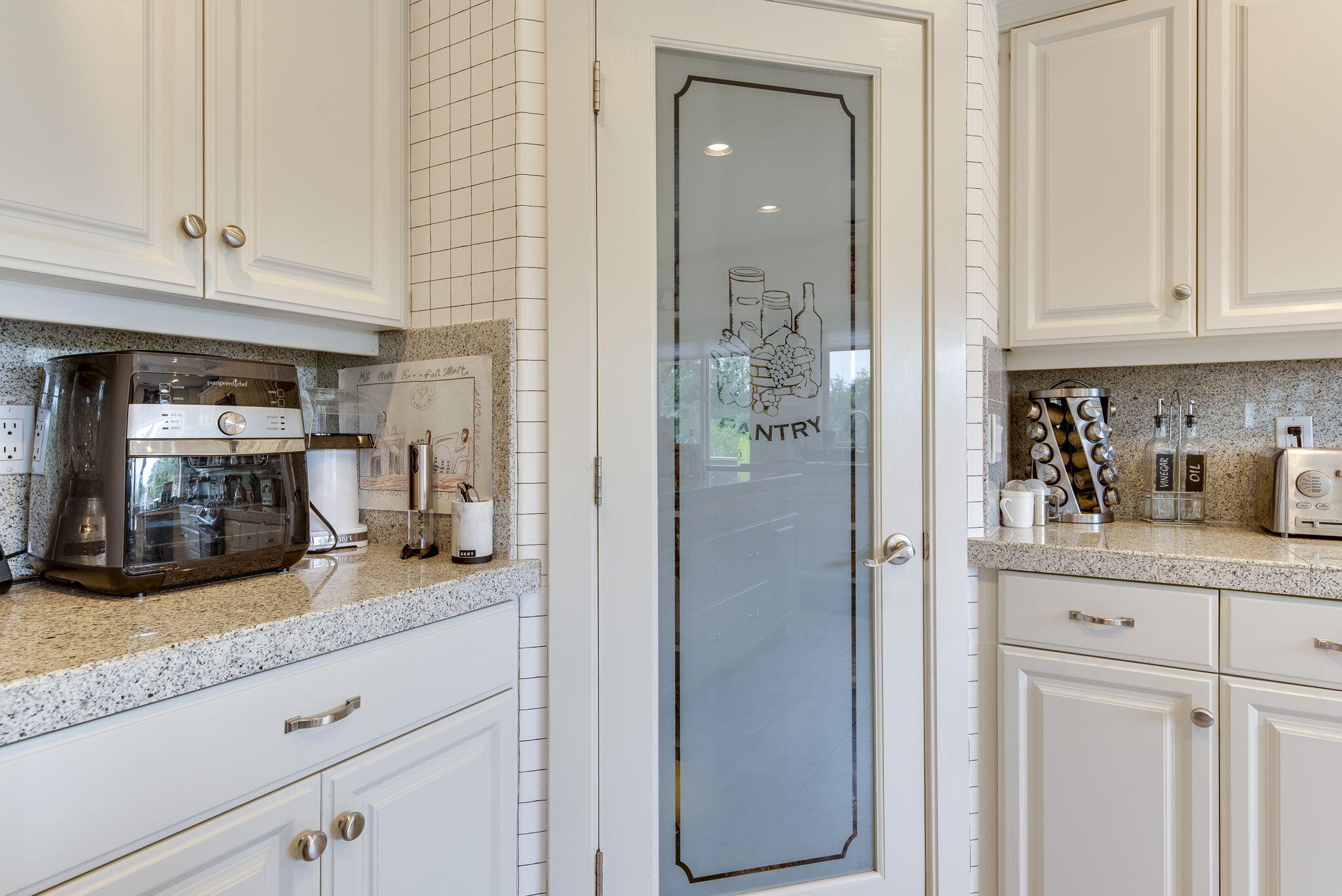 61538 Southeast Hill Ridge Road Bend, OR 97702 - Photo 21 of 59 a kitchen with granite countertop white cabinets and stainless steel appliances