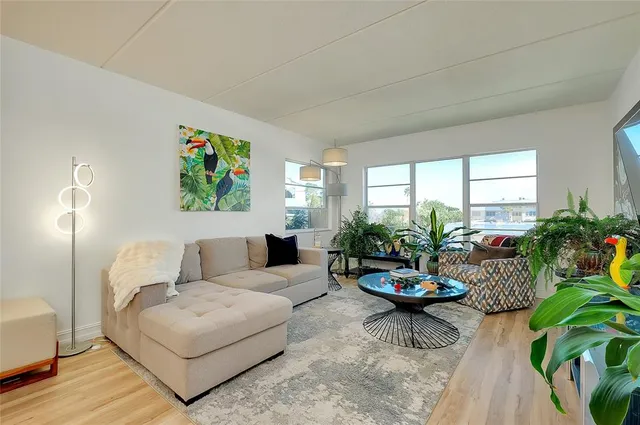 a kitchen with a sink a refrigerator and cabinets
