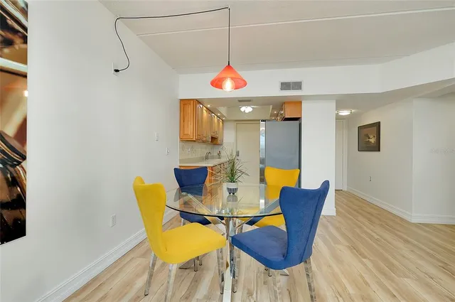 a kitchen with a sink a refrigerator and cabinets