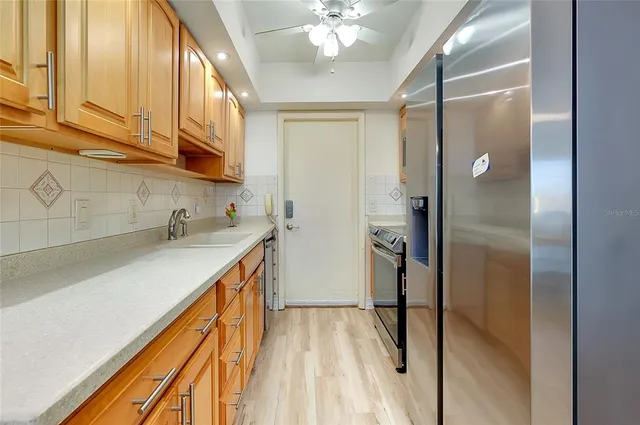 a bathroom with a granite countertop sink toilet a mirror and shower