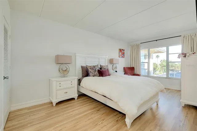 a large bed sitting in a bedroom and a flat tv screen