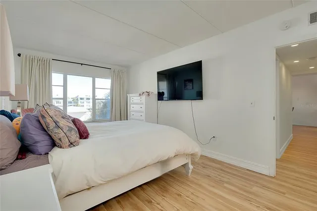 a bathroom with a granite countertop sink a mirror a shower and a toilet