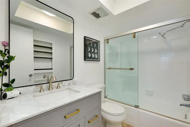 a bedroom with a bed window and a flat screen tv