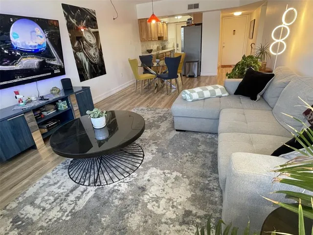 a living room with furniture and wooden floor