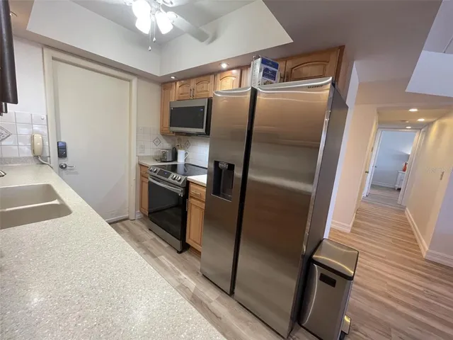 a kitchen with stainless steel appliances a refrigerator and a sink