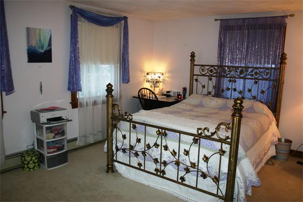 5 Orchard Road Gloucester, MA 01930 - Photo 16 of 23 a bedroom with a bed and a tv on table