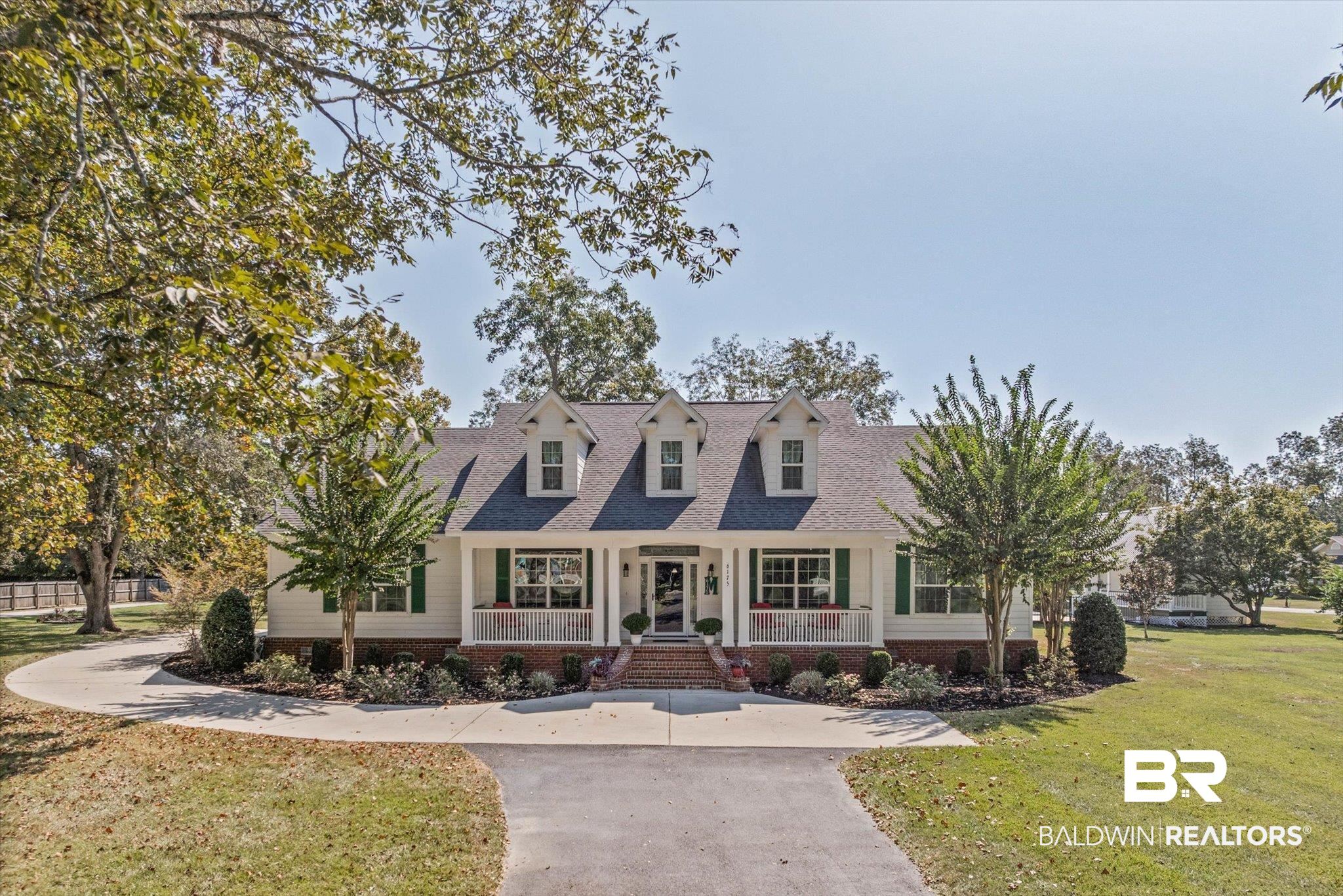 6175 South Grand Bay Wilmer Road Grand Bay, AL 36541 - Photo 33 of 42 Cape cod-style house with a porch, a front yard, a shingled roof, and asphalt driveway