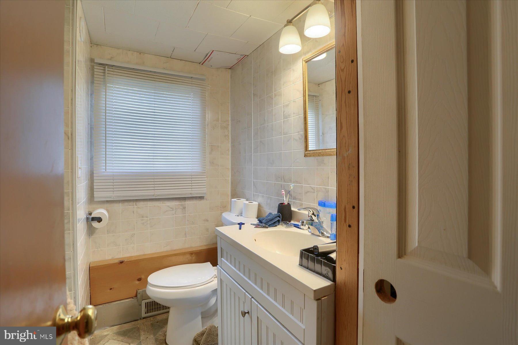 207 Mill Race Road Millerstown, PA 17062 - Photo 11 of 34 a bathroom with a sink a toilet and shower