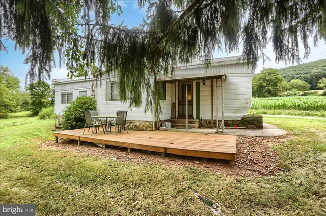a view of a house with swimming pool and a small yard