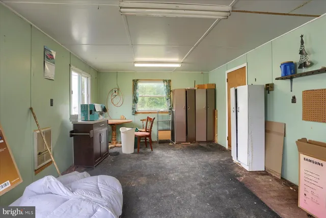 a view of a kitchen with refrigerator and furniture
