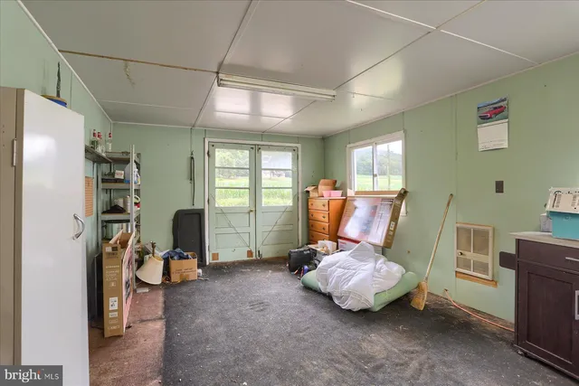 a room with furniture gym equipment and a window