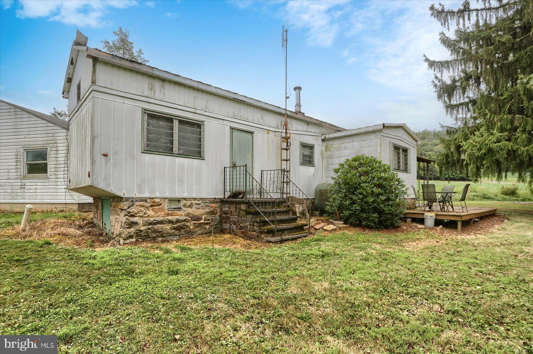 207 Mill Race Road Millerstown, PA 17062 - Photo 3 of 34 a backyard of a house with yard table and chairs