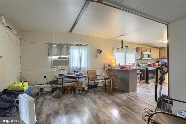 a living room with furniture a dining table and wooden floor