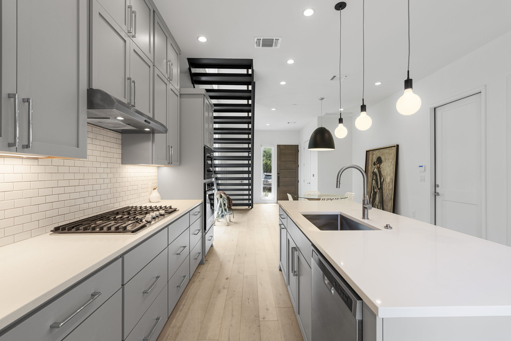 2520 Sutherland Street Austin, TX 78746 - Photo 5 of 26 Culinary delights await in this sleek kitchen, featuring an integrated oven and ample counter space.