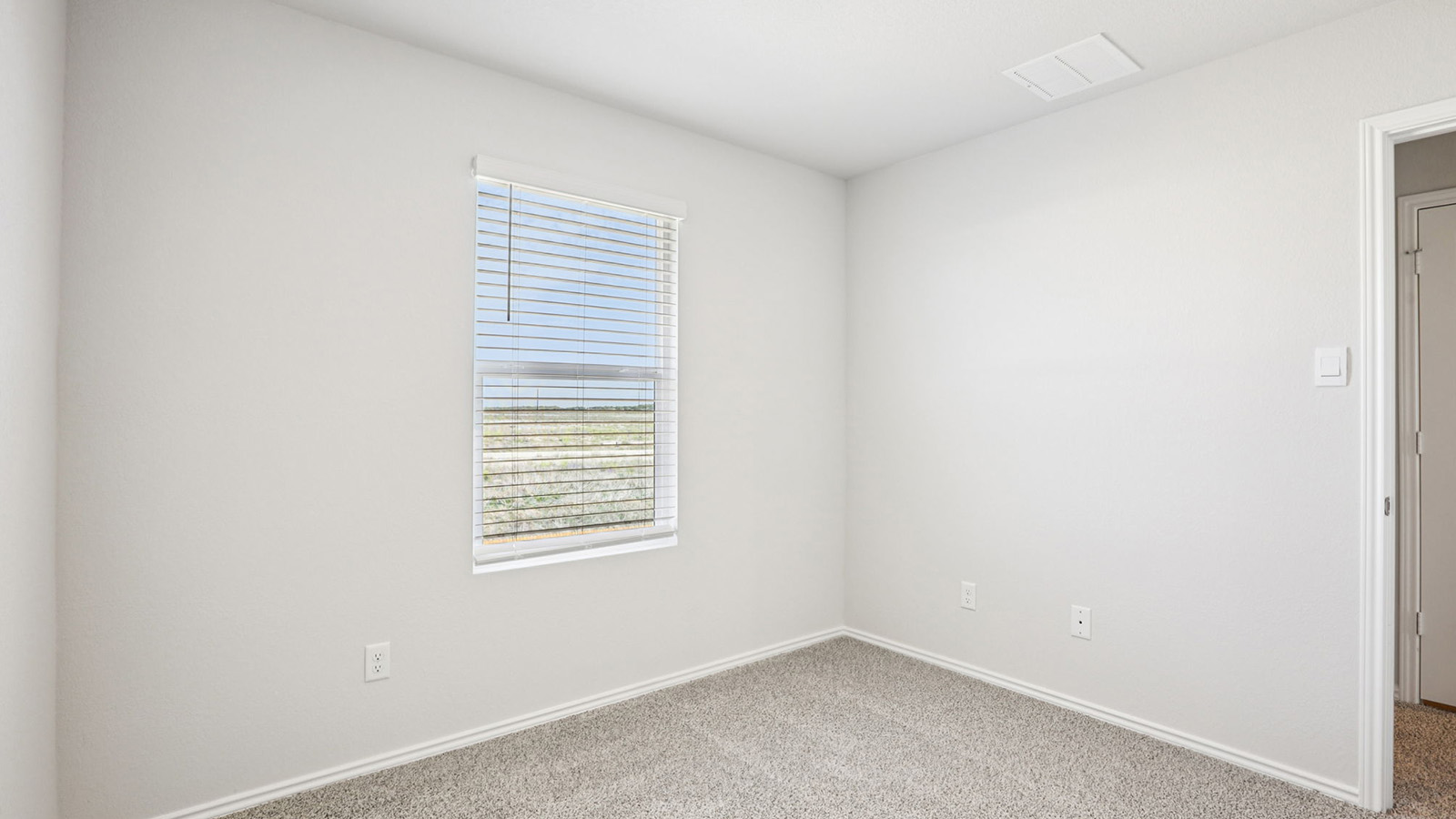 133 Wyatt Way Jarrell, TX 76537 - Photo 26 of 32 Bright room featuring neutral-toned walls, plush carpet flooring, a window with horizontal blinds, and a white interior door