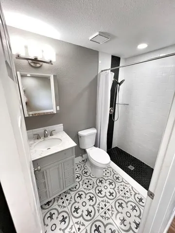 a bathroom with a sink toilet and shower