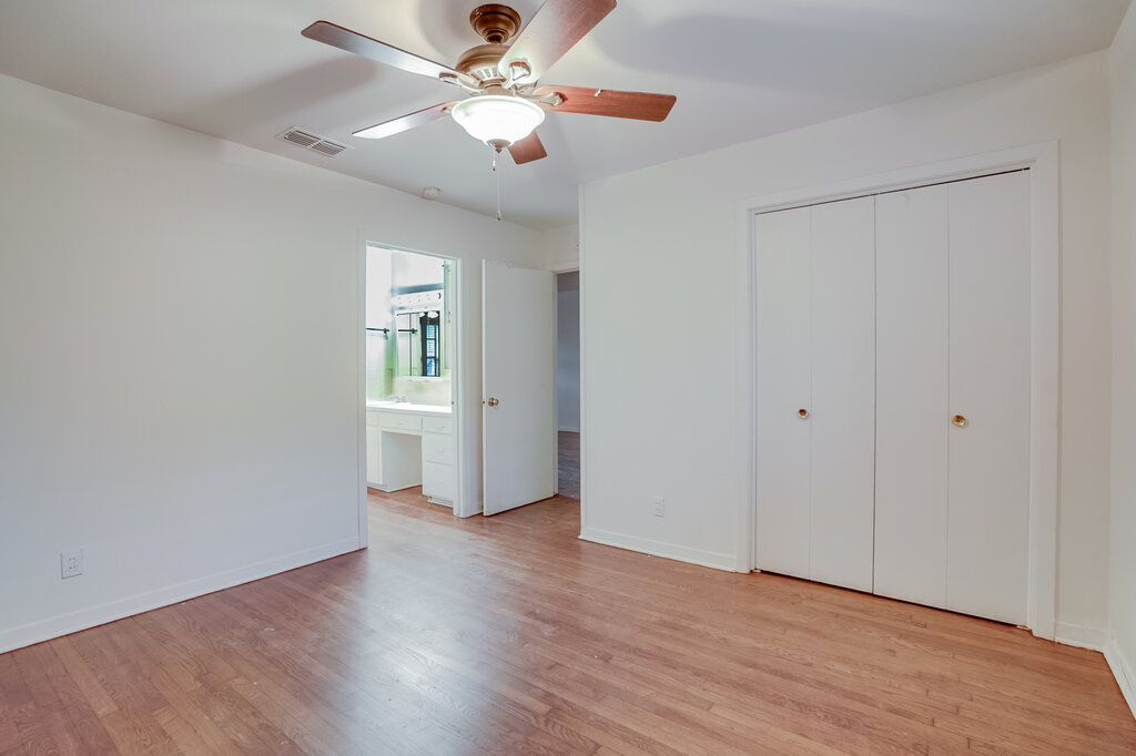 3707 Tom Green Street, Unit 2 Austin, TX 78705 - Photo 5 of 14 Unfurnished bedroom with light wood-style flooring, a ceiling fan, and a closet