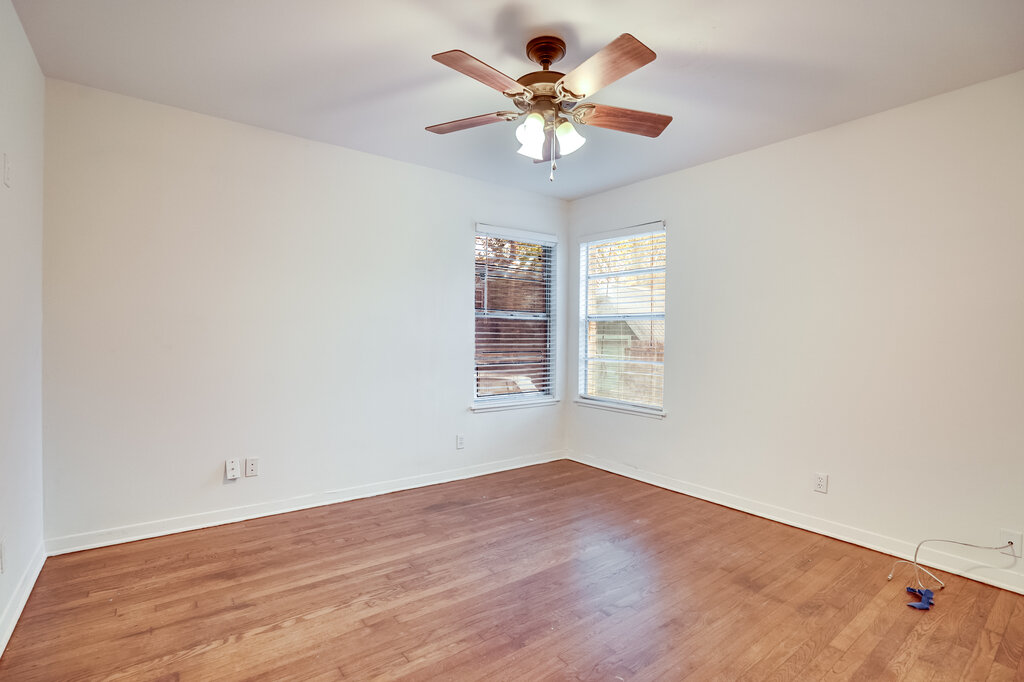 3707 Tom Green Street, Unit 2 Austin, TX 78705 - Photo 8 of 14 Empty room with wood finished floors and a ceiling fan