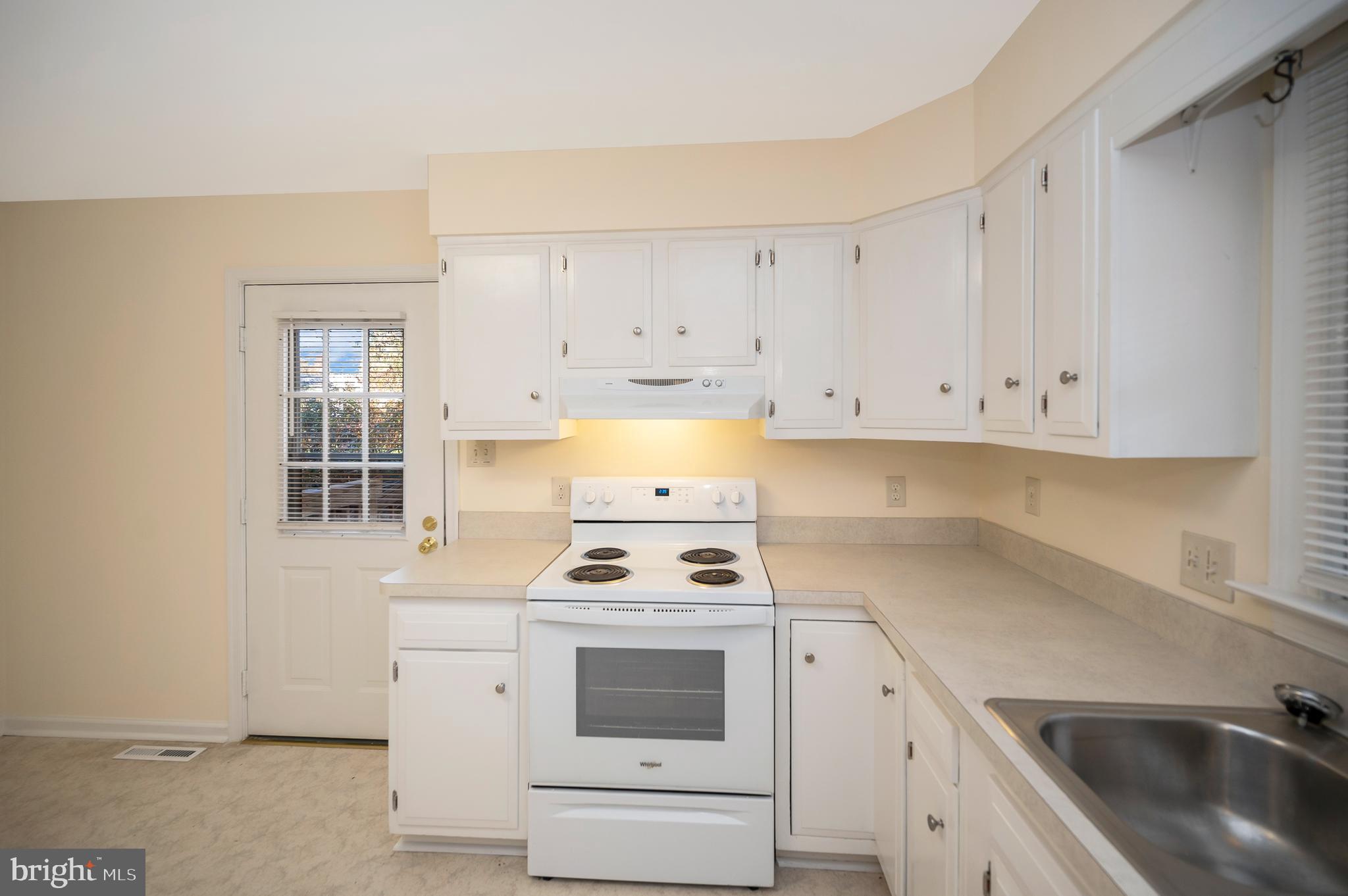 4 Randy Court Fredericksburg, VA 22407 - Photo 14 of 39 a kitchen with white cabinets and appliances