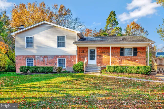 a front view of a house with a yard and potted plants