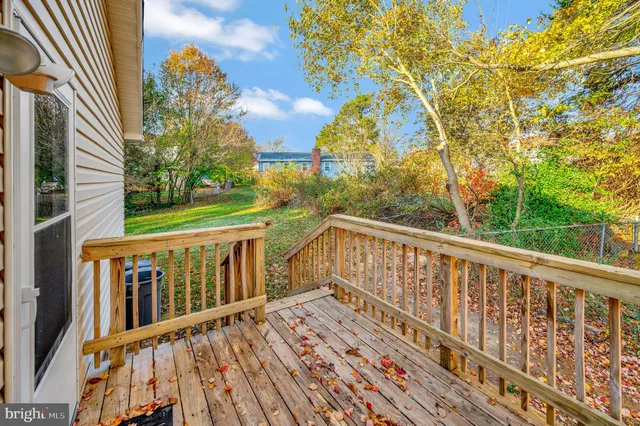 a view of a balcony with wooden floor and fence
