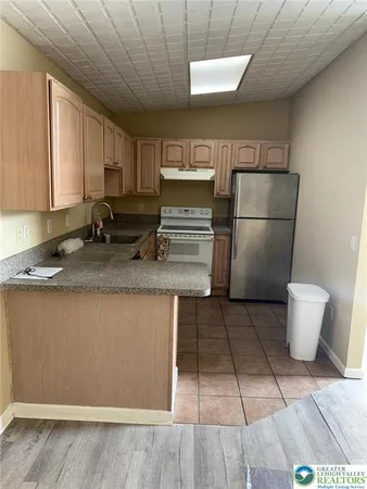a kitchen with a sink cabinets and appliances