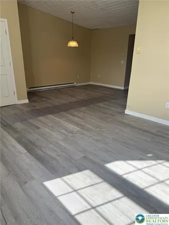 a view of an empty room and wooden floor