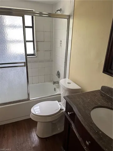 a view of a room with wooden floor closet and windows