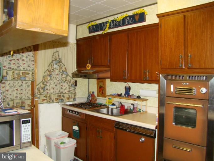 326 Dark Head Road Middle River, MD 21220 - Photo 16 of 22 a kitchen with stainless steel appliances wooden cabinets and a stove top oven
