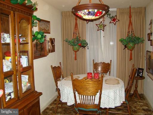 326 Dark Head Road Middle River, MD 21220 - Photo 10 of 22 a dining room with furniture potted plants and wooden floor