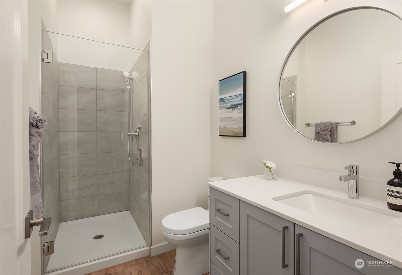 10322 Northeast 185th Street, Unit A Bothell, WA 98011 - Photo 13 of 22 a bathroom with a sink a toilet and shower
