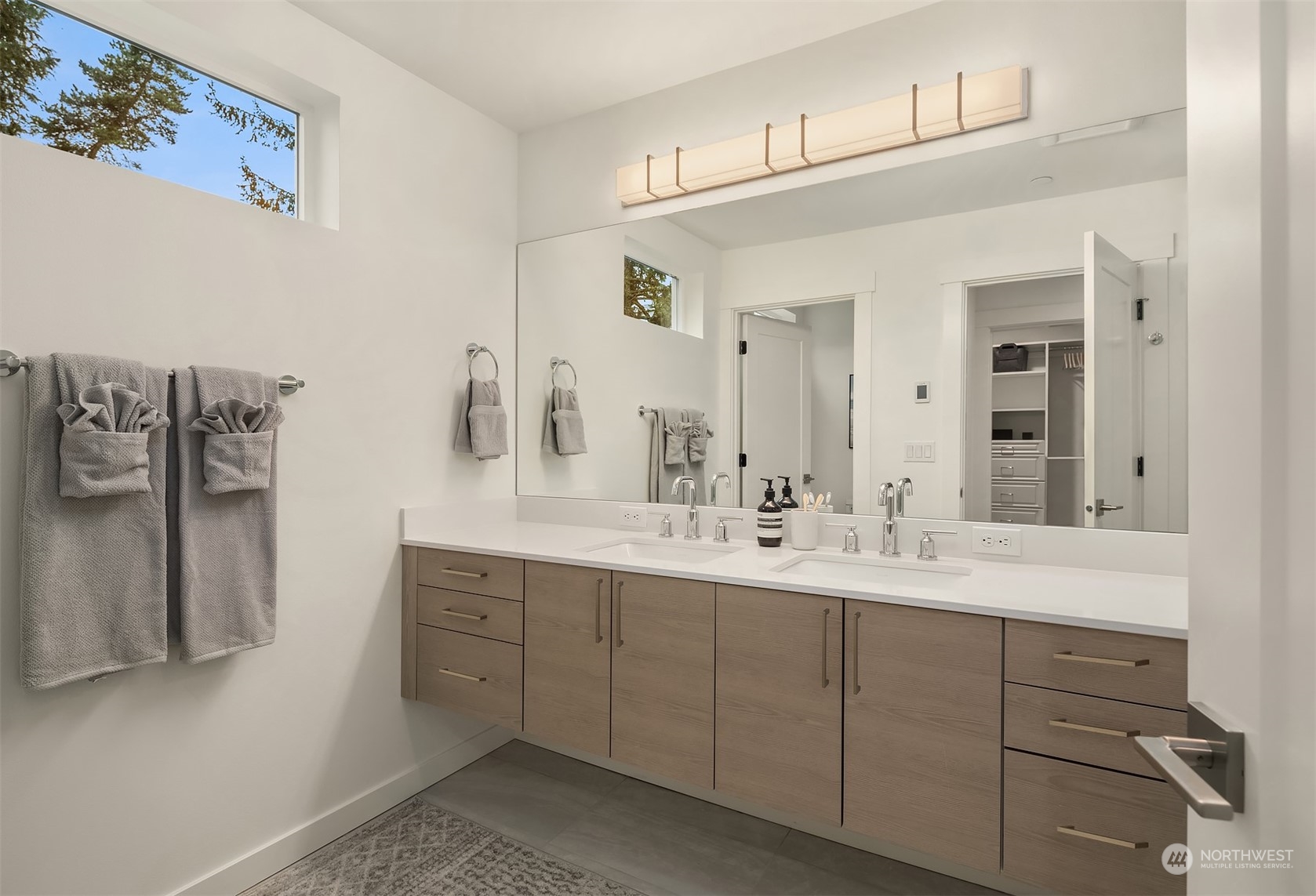10322 Northeast 185th Street, Unit A Bothell, WA 98011 - Photo 17 of 22 a bathroom with a double vanity sink and mirror