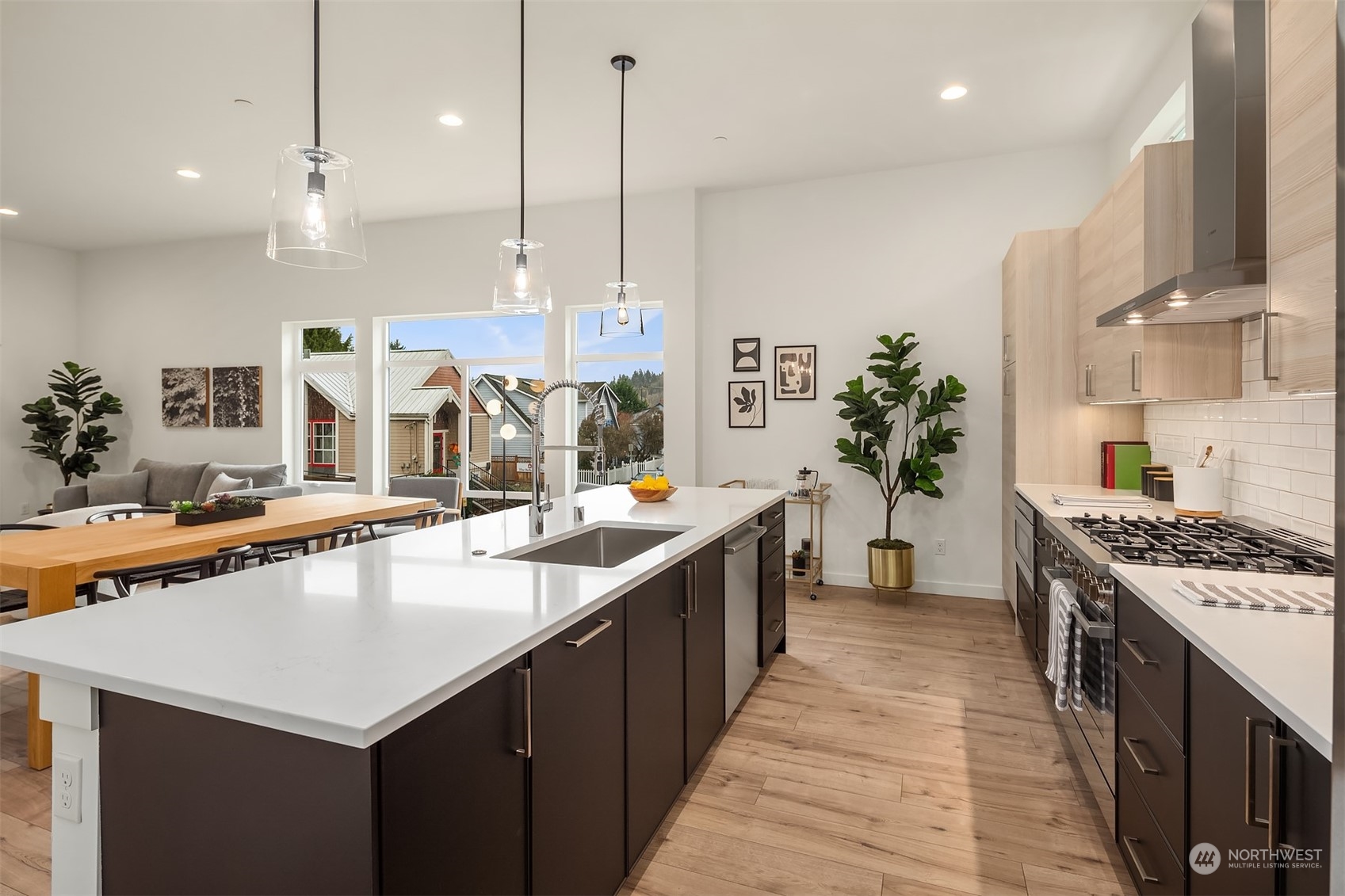 10322 Northeast 185th Street, Unit A Bothell, WA 98011 - Photo 7 of 22 a kitchen with stainless steel appliances granite countertop a sink a counter top space a stove and a wooden floors
