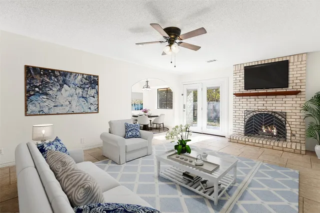 a living room with furniture a fireplace and a flat screen tv