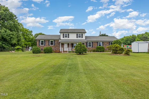a front view of a house with a garden