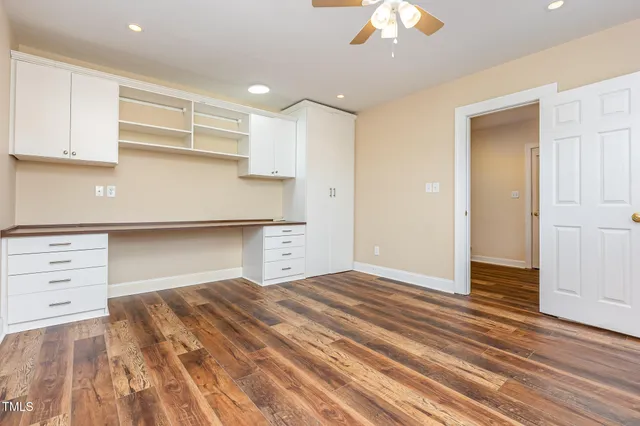 a room with a dresser and chandelier