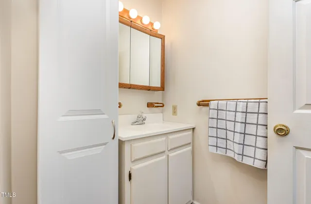 a bathroom with a sink a toilet and mirror