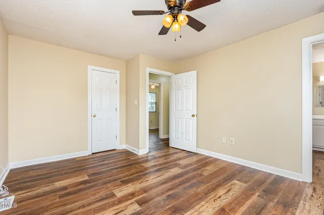 a view of an empty room and wooden floor