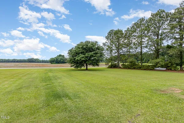 a view of yard with swimming pool and green space