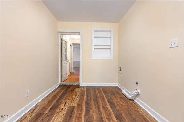 a view of a room with wooden floor and a window