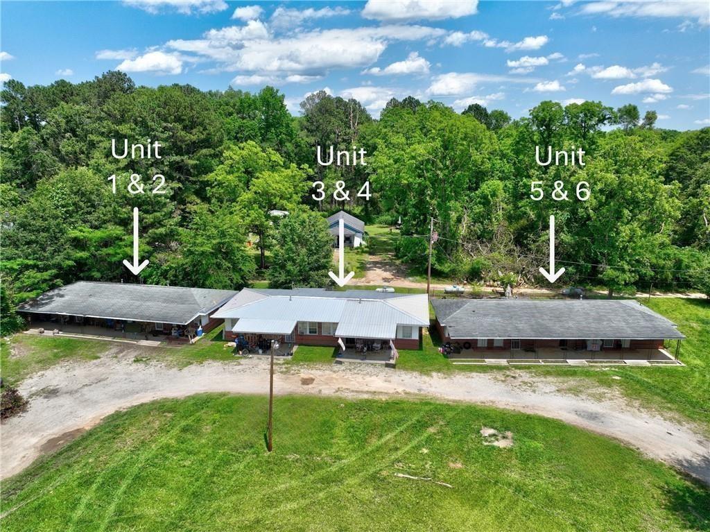a view of a house with pool and a yard
