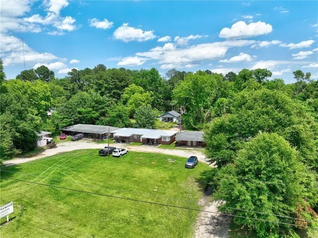 an aerial view of a house with a yard