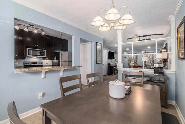 a kitchen with granite countertop a stove and a refrigerator