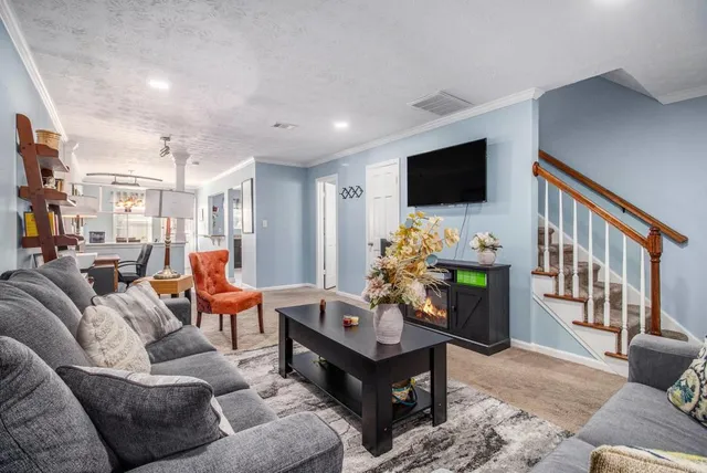 a living room with furniture and a flat screen tv
