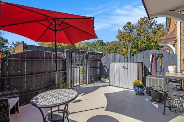 a front view of a house with a yard and potted plants