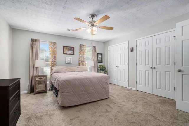 a bedroom with a large bed and a chandelier