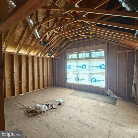 a view of a room with large trees and plants