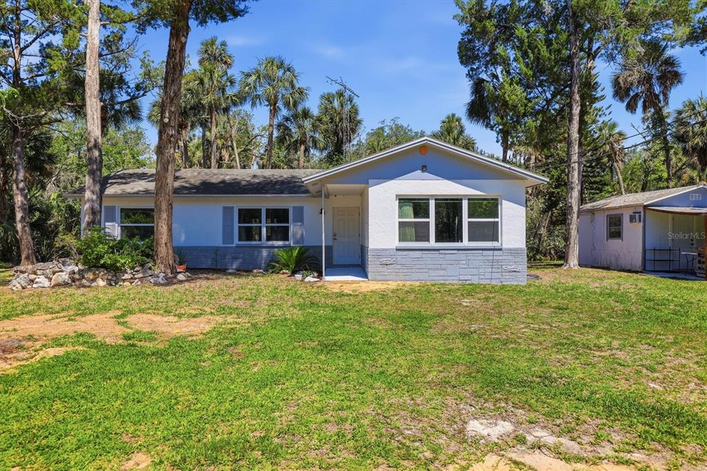 6244 Colony Circle Weeki Wachee, FL 34607 - Photo 2 of 60 a front view of a house with a garden