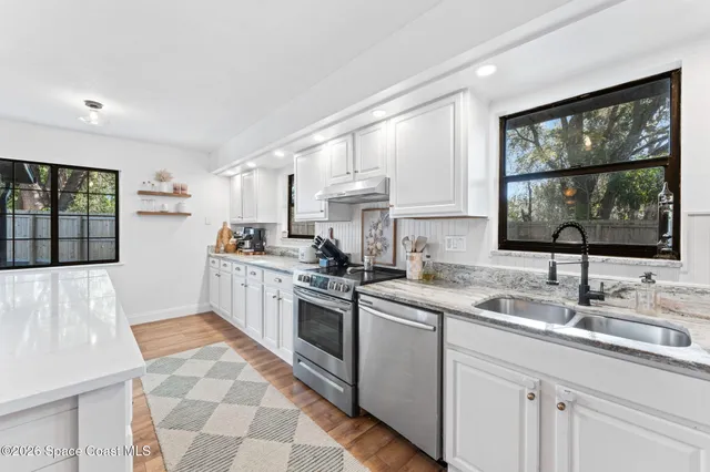 a kitchen with a sink stove and cabinets