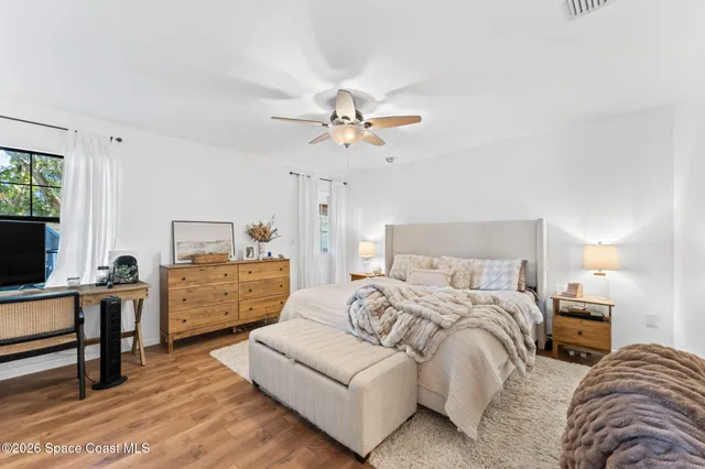 a bedroom with furniture and a chandelier